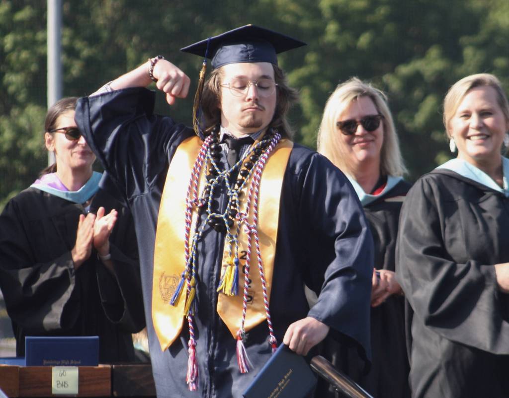 Graduate Cameron Tyler poses with his diploma.