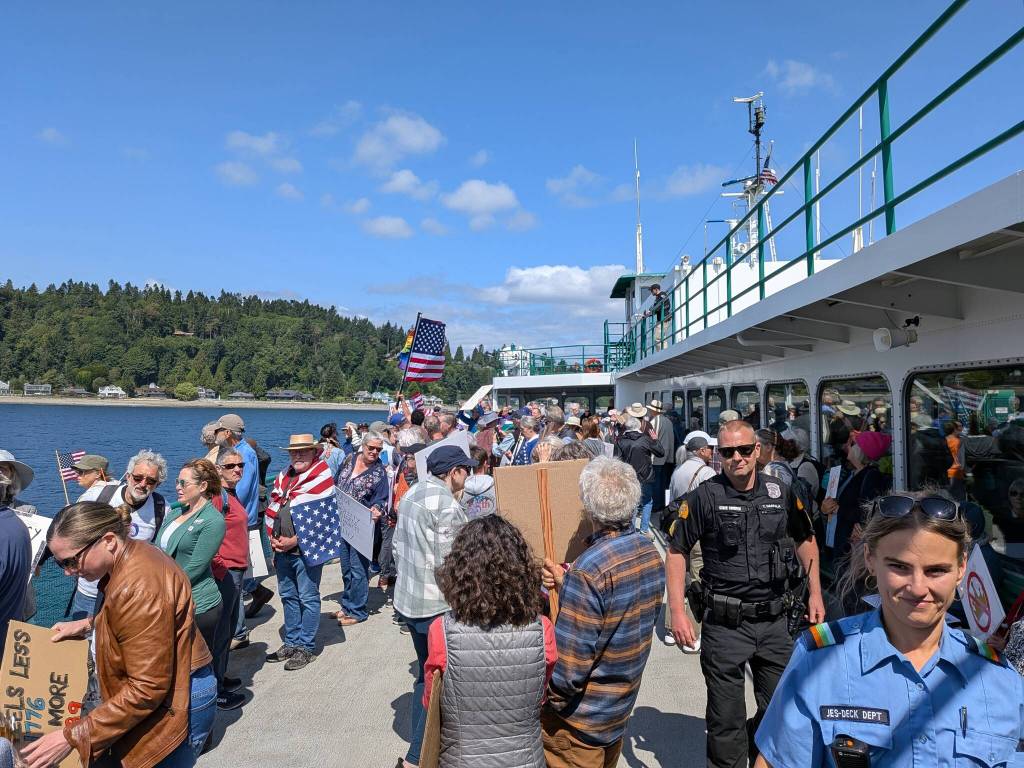 Hundreds of protesters boarded the 10:25 a.m. Bainbridge to Seattle ferry.