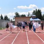 Color Guard members practice their routine while marching around the track at Memorial Field.