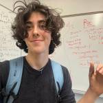 Ella McRitchie courtesy photos
McRitchie smiles and gestures toward her calculations, displaying stitches on her thumb from a pole-vaulting accident.