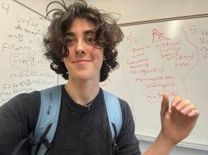 Ella McRitchie courtesy photos
McRitchie smiles and gestures toward her calculations, displaying stitches on her thumb from a pole-vaulting accident.