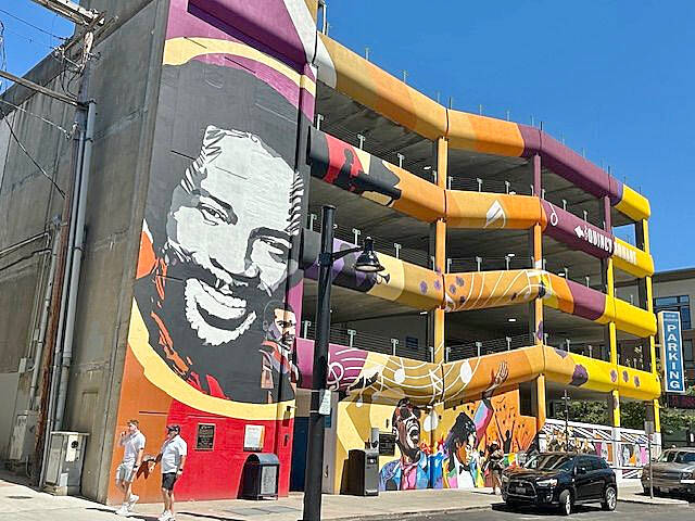 Quincy Jones, namesake of Quincy Square, highlights a colorful wall mural on the city parking garage at 4th Street and Washington Avenue.