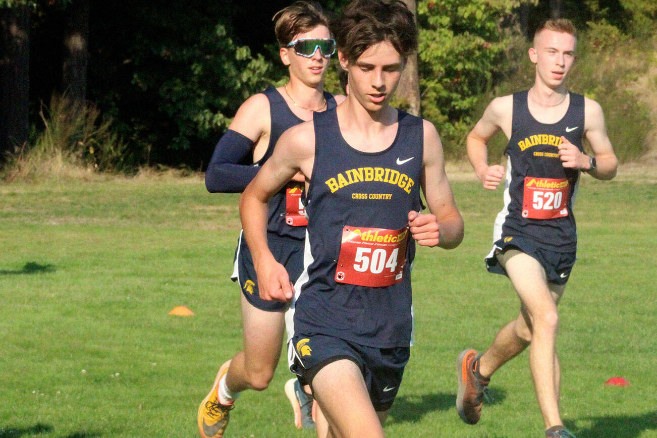 Bainbridge Spartans Mylo Burrows, Miles Fuss, and Hawkeye Grumm compete in the boys cross-country 2-mile varsity event Sept. 3 at the Kitsap County Fairgrounds.