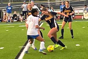 Luke Caputo/Kitsap News Group
Spartan Siri Smith pushes the ball past an incoming Olympic defender in a 7-0 Bainbridge home win Sept. 11.