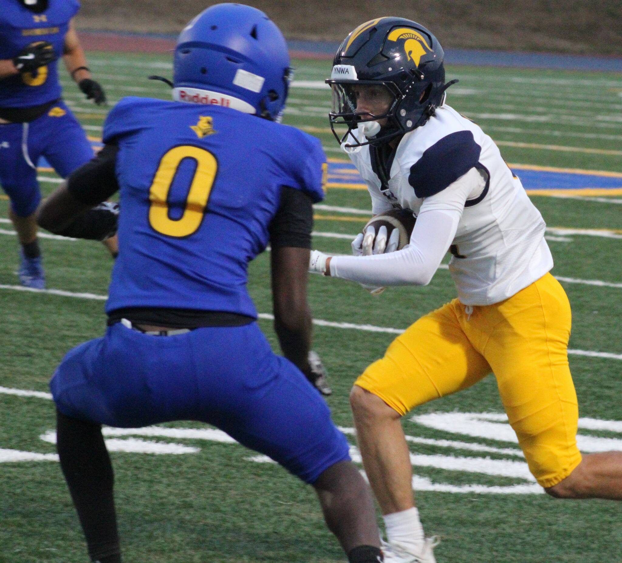 Bainbridge Spartan Max Fitzgerald looks to make a play with Knight Enoch Taylor in pursuit in a Bremerton home win Sept. 19.