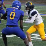 Bainbridge Spartan Max Fitzgerald looks to make a play with Knight Enoch Taylor in pursuit in a Bremerton home win Sept. 19.
