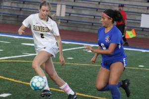 Luke Caputo/Kitsap News Group photos
Spartan Maggie Dunstan and Knight Akina Pritchard compete for the ball in a 6-0 Bainbridge win Sept. 23 in Bremerton.