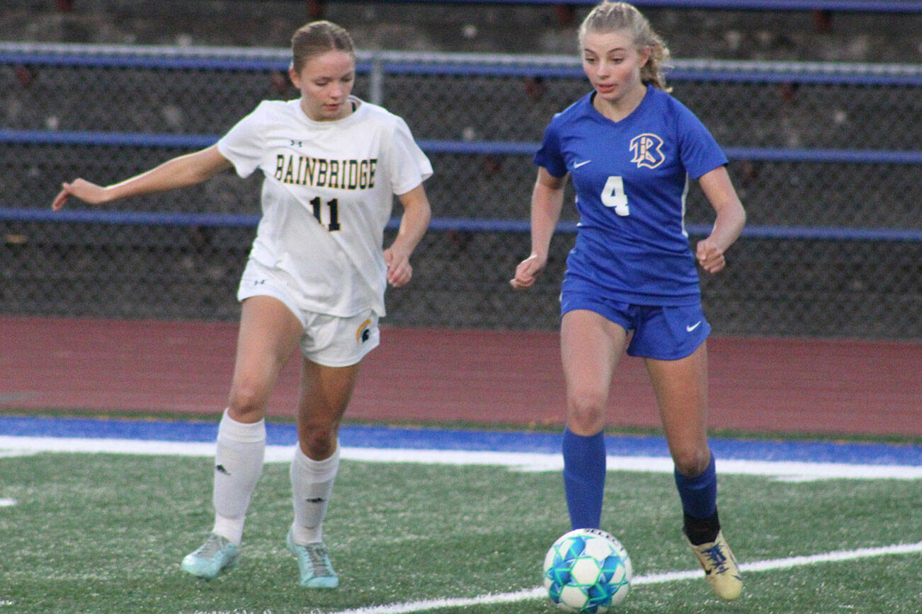 Spartan Eliza Jurcek and Knight Melanie Uhrich vie for the ball in a 6-0 Bainbridge win over Bremerton Sept. 23.