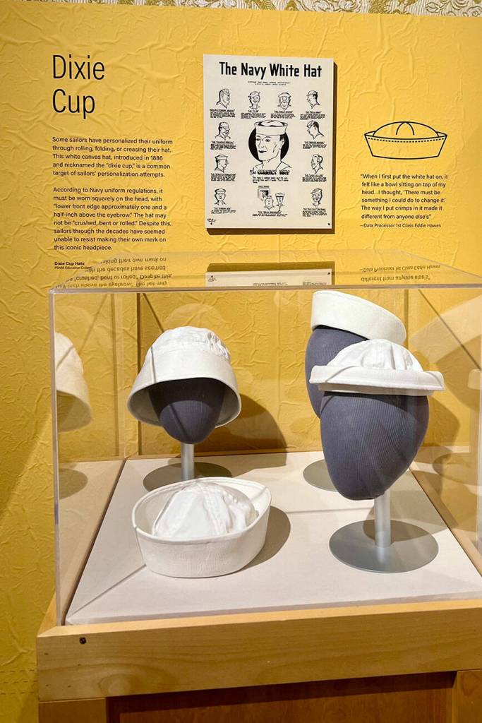 The exhibit shows the white canvas hat, introduced in 1886, also known as the Dixie cup.