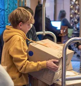 Holland America Line courtesy photo
An Odyssey Middle School student helps load a box of supplies on the ship Noordam, which will be en route to underserved schools in the Solomon Islands.