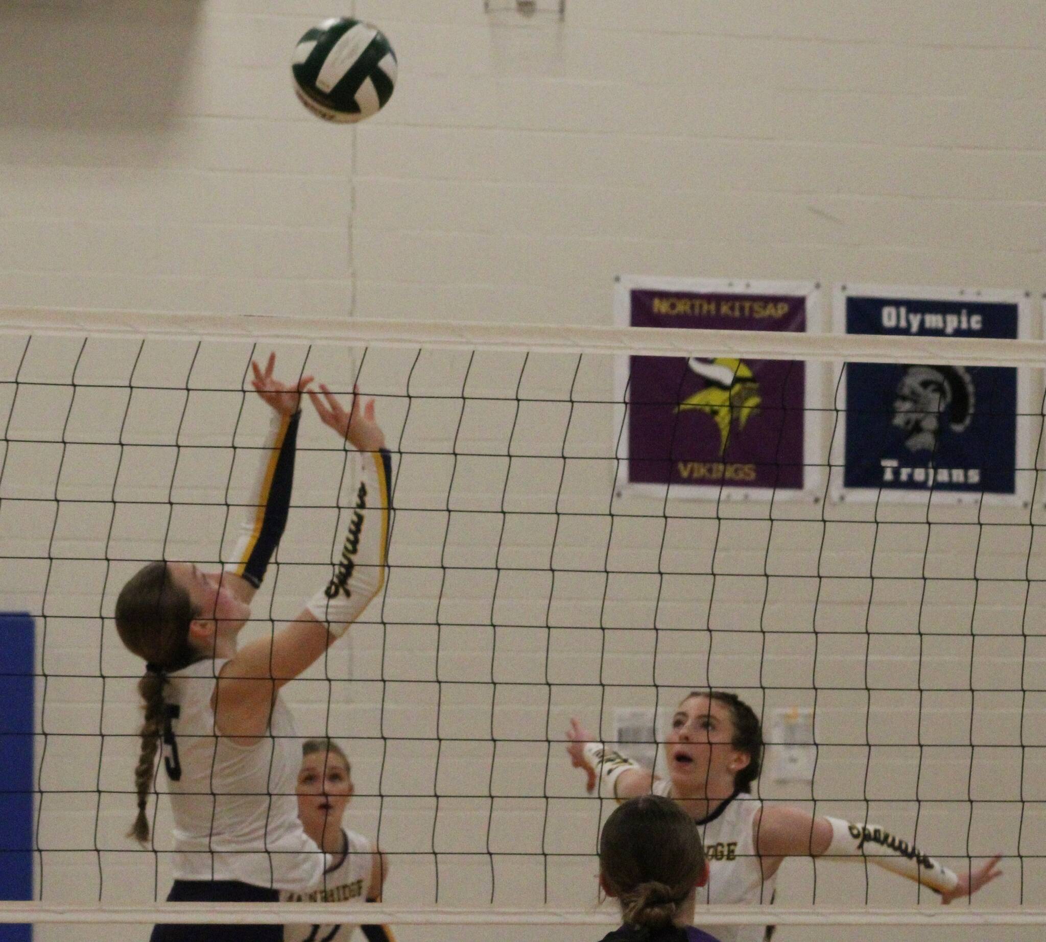 Spartan designated setter Farrah Colby sets the ball for right-side hitter Cate Torrell to spike in a 3-0 Bainbridge win over the North Kitsap Vikings Nov. 8 in the semifinals of the District 3 2A volleyball tournament at North Mason High School.