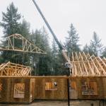 KFM Construction courtesy photo
Derek Moore, co-owner of KFM Construction and a veteran, moves a beam on the roof of Bomkes soon-to-be home.