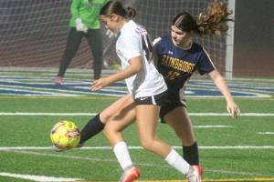 Luke Caputo/Kitsap News Group photos
Spartan Abril Edwards fights for the ball with an Anacortes player in a 4-3 Bainbridge home loss to the Anacortes Seahawks in the quarterfinals of the 2A girls state soccer tournament Nov. 15.