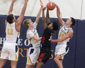 Luke Caputo/Kitsap News Group photos
Spartan Ryan Rohrbacher blocks a Palm Springs players shot with Will Rohrbacher and Lane McFadden defending in a 64-58 Bainbridge home win against Palm Springs Dec. 3.