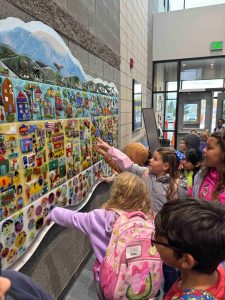 Diane Bonciolini courtesy photos
Students at Summitview Elementary in Yakima take a look at their finished work in the mural they created with Mesolini Glass Studios.
