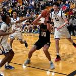 Spartan Ryan Rohrbacher attempts to get a shot off with Knights Junior Davis-McWhorter, Aaron Matthews, and Jay Beahan closing in during a 71-42 Bremerton home win over Bainbridge Dec. 16.
