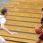 Buccaneer Vaka Tameilau looks to make a play with Spartan Kethan Reed defending in an 81-43 Bainbridge home win over Kingston Jan. 6.