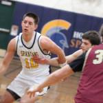 Luke Caputo/Kitsap News Group photos   
Spartan Ryan Rohrbacher dribbles the ball up the court with Buccaneers Ethan Hackett and Derek Bynum defending in an 81-43 Bainbridge home win over Kingston Jan. 6.