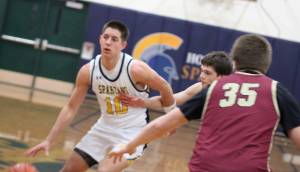 Luke Caputo/Kitsap News Group photos   
Spartan Ryan Rohrbacher dribbles the ball up the court with Buccaneers Ethan Hackett and Derek Bynum defending in an 81-43 Bainbridge home win over Kingston Jan. 6.