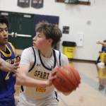 Spartan Julien Zupan looks to make a pass with Knight Aaron Matthews defending him in an 84-41 Bainbridge home loss to Bremerton Jan. 27.