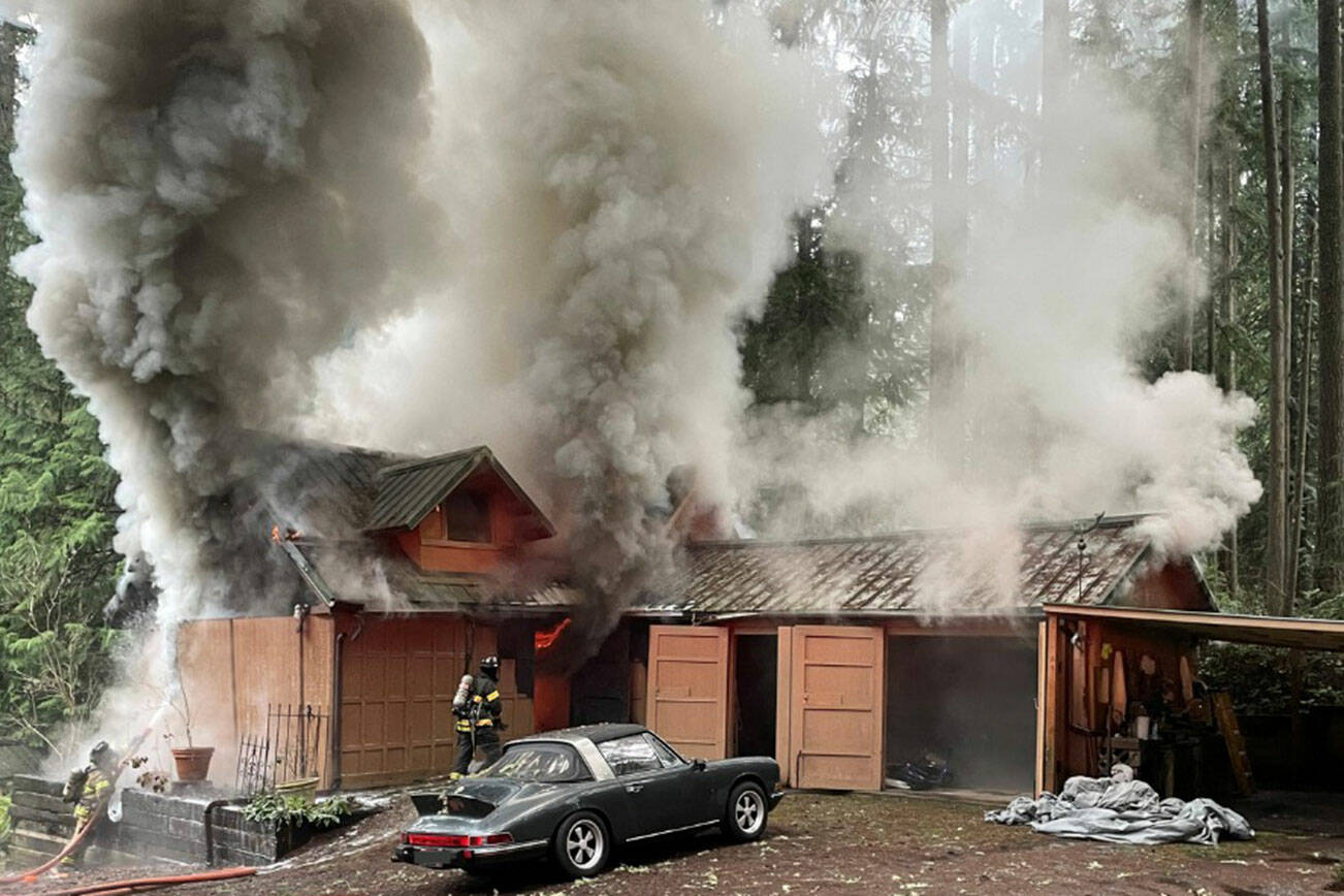 BIFD courtesy photo
Firefighters battle a blaze at a storage building at a Bainbridge Island residence Jan. 30.