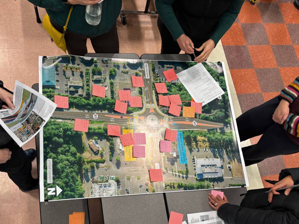 Molly Hetherwick/Kitsap News Group
Community members discuss a proposed roundabout project at the intersection of Hwy 305 and High School Road during an open house Feb. 11.