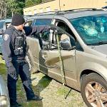 Bainbridge Island Police Department officer Brenton Miller documents vehicle damage during an accident training session.
