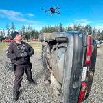 Poulsbo Police Department Sgt. Luke Bogues deploys a drone to take aerial photos of a staged accident.