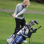 Trojan Roger Gasow hits an approach shot in a 155-208 Olympic loss to Bainbridge March 12 at Kitsap Golf & Country Club in Bremerton.