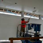 A worker applies a fresh coat of paint inside the facility.