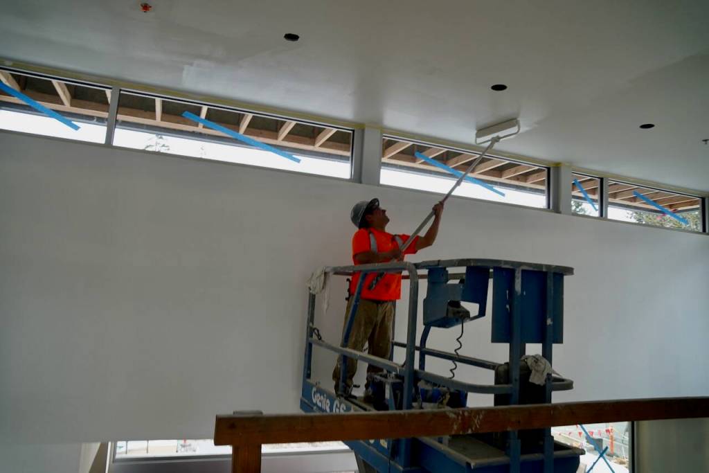 A worker applies a fresh coat of paint inside the facility.
