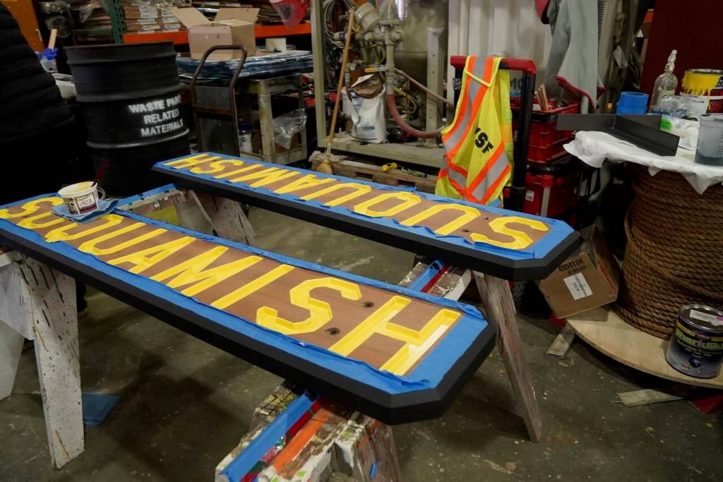 The wood shop features a sign for the M/V Suquamish.
