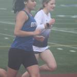 Bainbridge Spartan Vega Hendrickson and Olympic Trojan Ava Siyluy compete in the girls 1600-meters April 15 at Integrity Roofing Stadium in Bremerton.