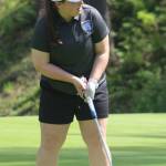 Olympic Trojan first-place finisher Chelsea Baven strokes a putt into the final hole during the Olympic League Golf Championships May 4 at Kitsap Golf & Country Club in Bremerton.
