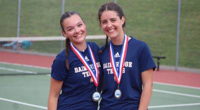 Luke Caputo/Kitsap News Group photos
Bainbridge Spartans Abby Schnee (left) and Elsa Drugge (right) celebrate their first-place doubles finish at the Olympic League Girls Tennis Tournament May 8 at North Kitsap High School.