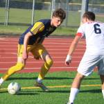 Spartan Howard Howlett IV navigating the ball around a defender during a 5-0 home win over the Nathan Hale Raiders May 22 in the 2A state quarterfinals.