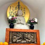 A sandstone Buddha is featured at the peace pagoda.
