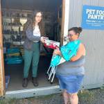 Mike De Felice/Kitsap News Group photos
Cindy Townson, of Seabeck, (right) picks up pet food for her dogs, Roxy and Duke.