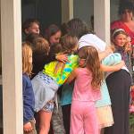 Katherine Bouma/Kitsap News Group
MCS head of school Meghan Kane Skotheim, who is retiring after 32 years, receives hugs from students during a ceremonial picnic June 5.